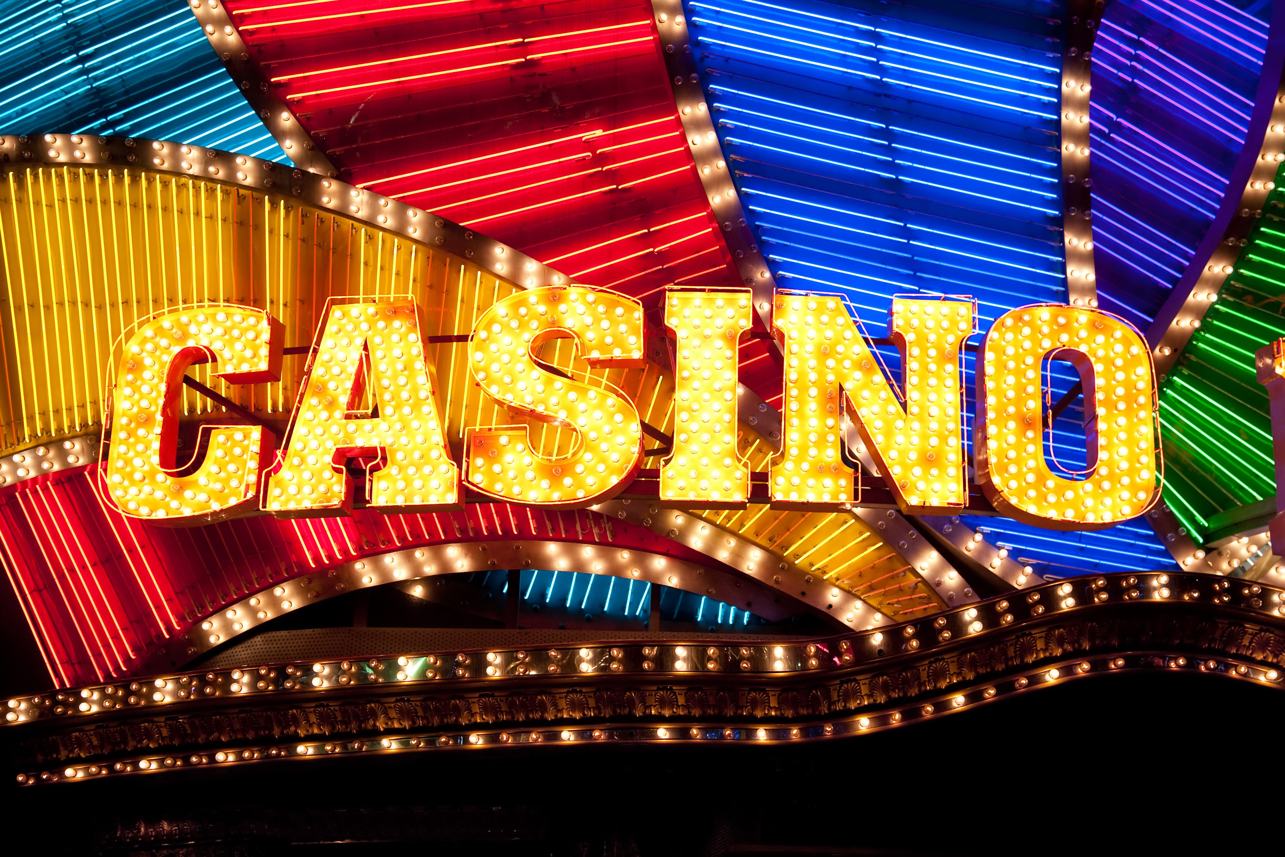 A vibrant graphic showcasing a custom avatar standing in front of their personalized casino city in Casino World.